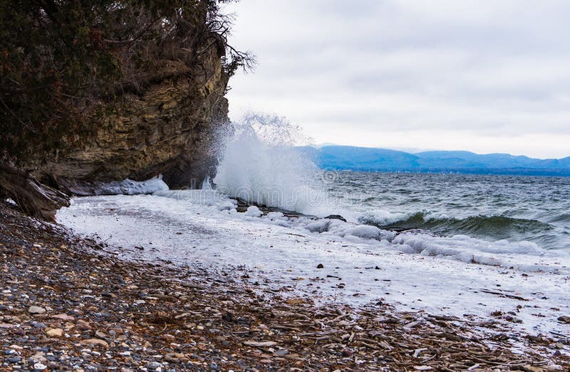 Waves crashing on frozen lakeshore