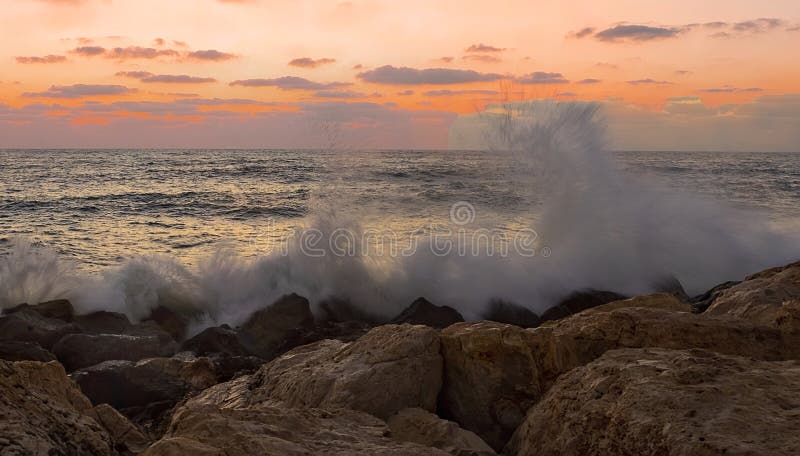 Waves Crashing Onto Rocks At Sunset Stock Photo Image Of Crashing Ripples 155527070