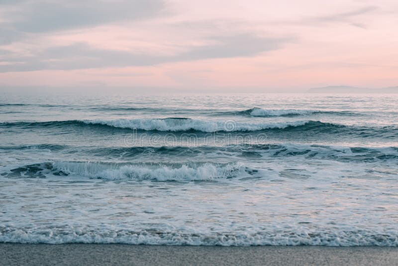 Waves in Pacific Ocean at sunset, in Newport Beach, Orange County, California