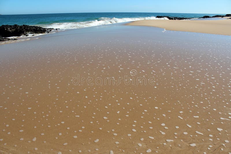 Waves splashing on basalt rocks at Ocean beach Bunbury Western Australia