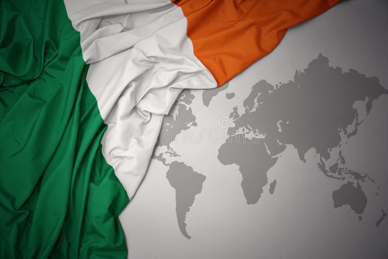 Waving colorful national flag of ireland on a gray world map background. Waving colorful national flag of ireland on a gray world map background.