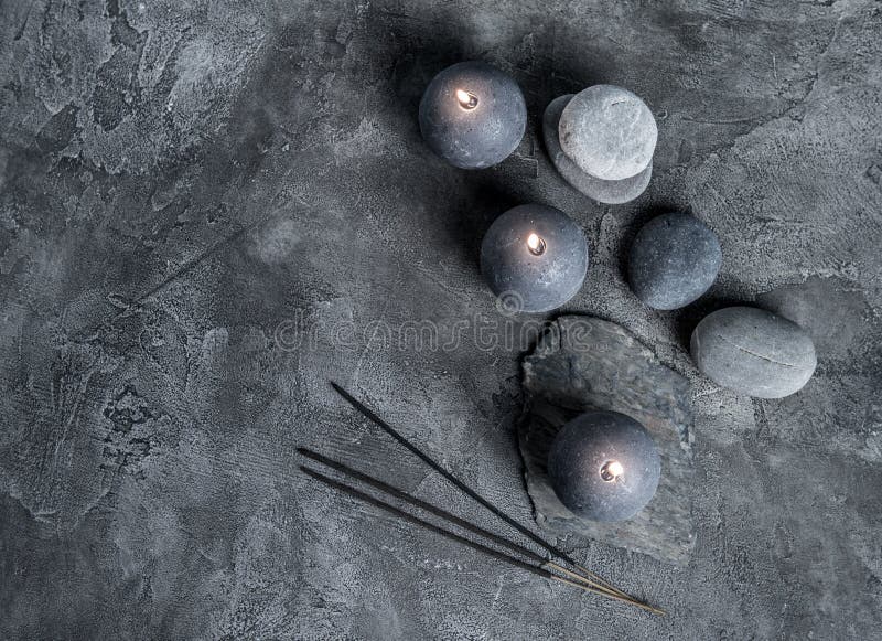 Wax candles and massage stones, top view