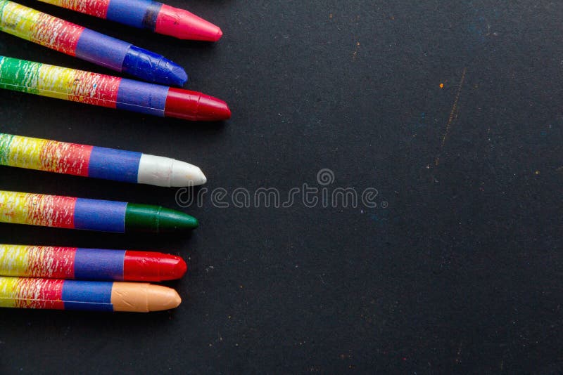 Wax crayons on black paper stock photo. Image of idea 201167916