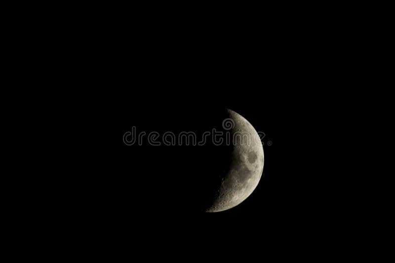 Waxing crescent moon against a black sky stock photography