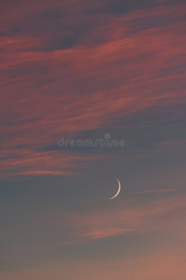 Waxing Crescent Moon and evening glow stock photo