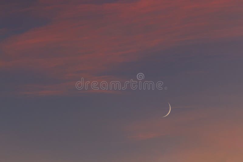 Waxing Crescent Moon and evening glow stock image