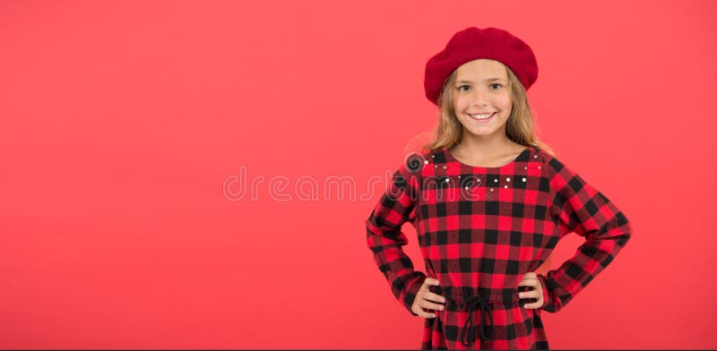 Wear beret like fashion girl. Kid little cute girl with long blonde hair posing in beret hat and checkered dress red