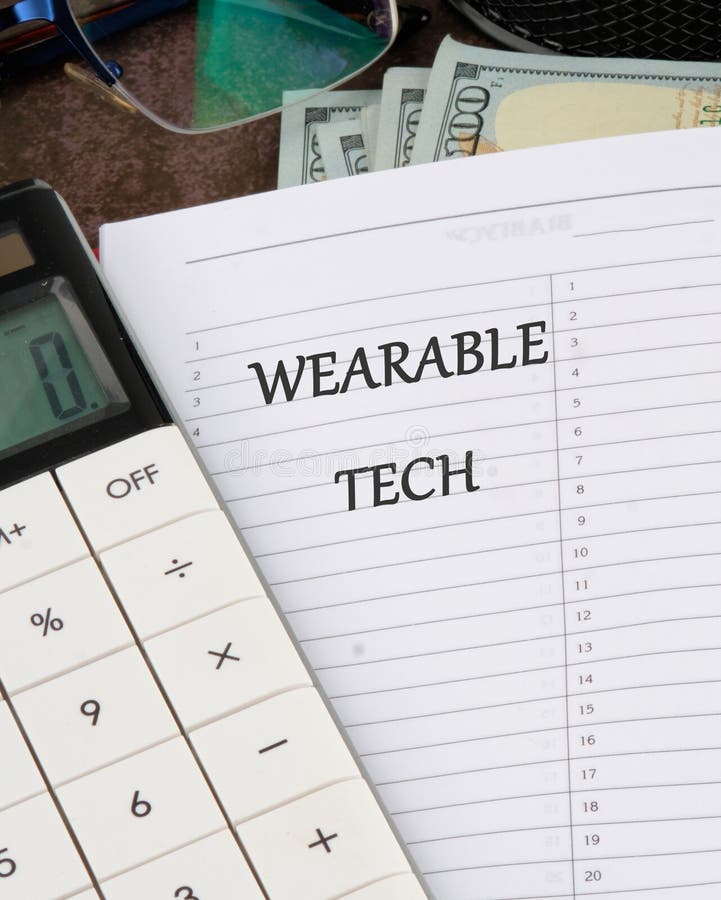 Wearable computing concept. The concept of technology. WEARABLE TECH Concept Text it is written in a notebook on a royalty free stock images