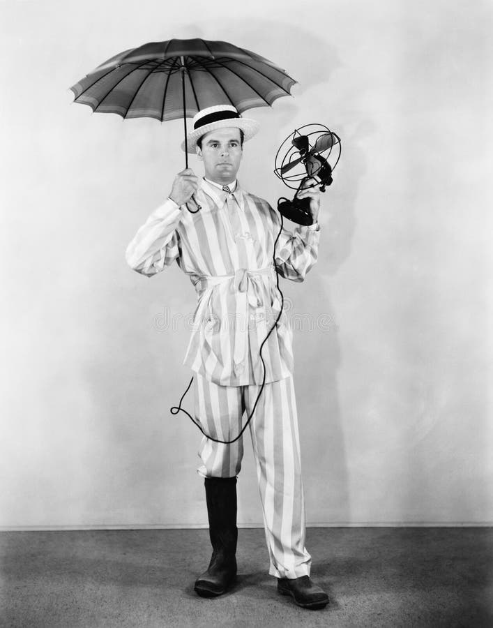 The weather man with umbrella, boot and fan royalty free stock photos
