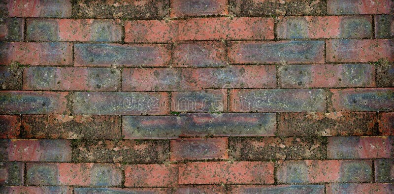 Weathered brick wall is appearing in flat design, featuring red bricks with moss patches royalty free stock photo