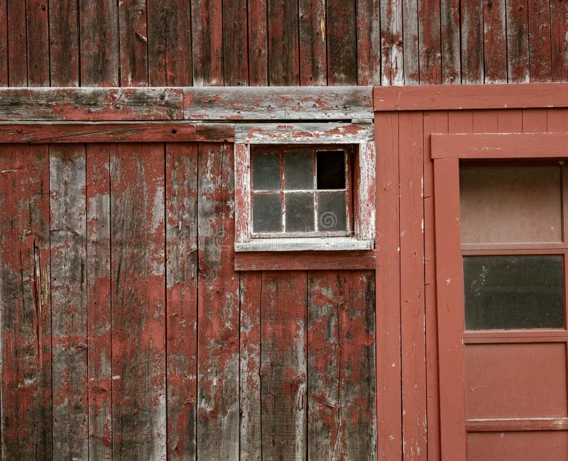 Weathered red paint and broken windows are a common site on barns stock photos