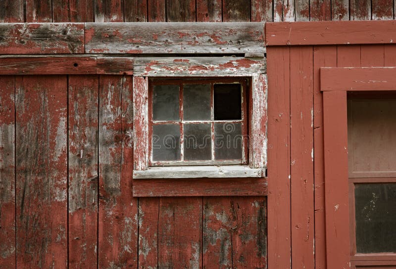Weathered red paint and broken windows are a common site on barns royalty free stock photos
