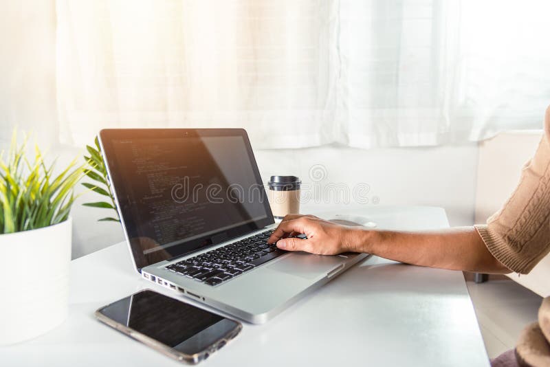 Web application development. programmer woman writing program code sitting at workplace in office, software developer hands coding HTML programming with laptop computer, IT start up concept, back view