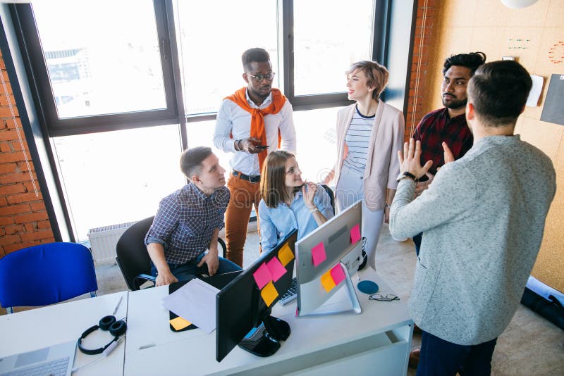 Web-designers are discussing their perspective plans at workplace royalty free stock image Web-designers are discussing their perspective plans at workplace royalty free stock image