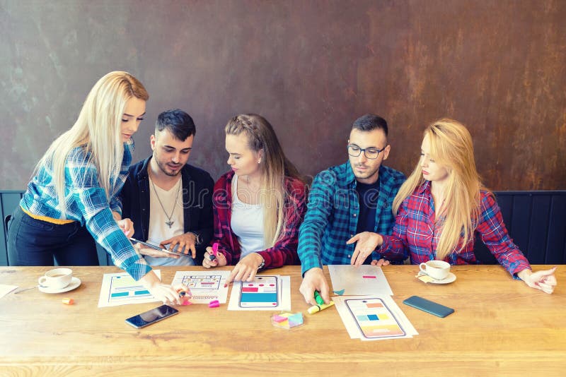 Website development project with team of creative young web designers at work stock images Website development project with team of creative young web designers at work stock images