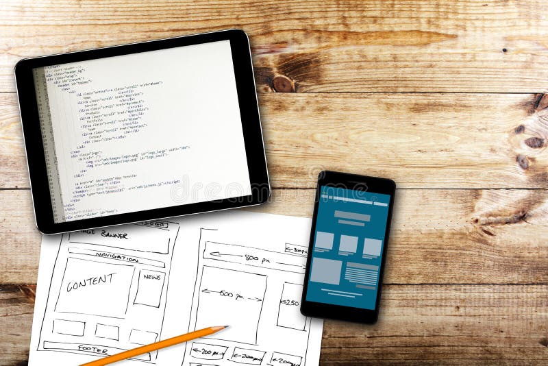 Website wireframe sketch and programming code on digital tablet stock images Website wireframe sketch and programming code on digital tablet stock images