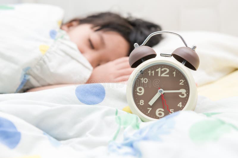 Alarm clock and girl sleep on background. Alarm clock and girl sleep on background