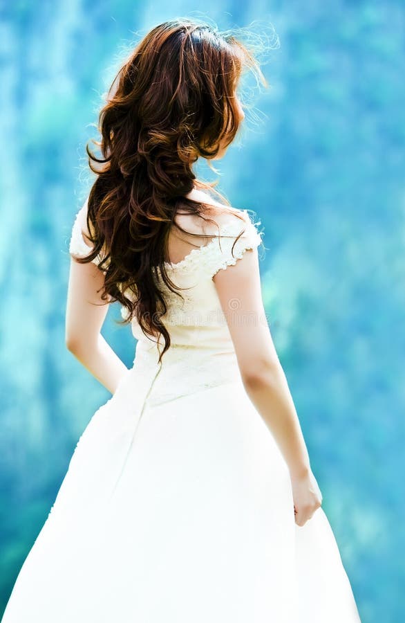 Bride in wedding dress, isolated on blue background