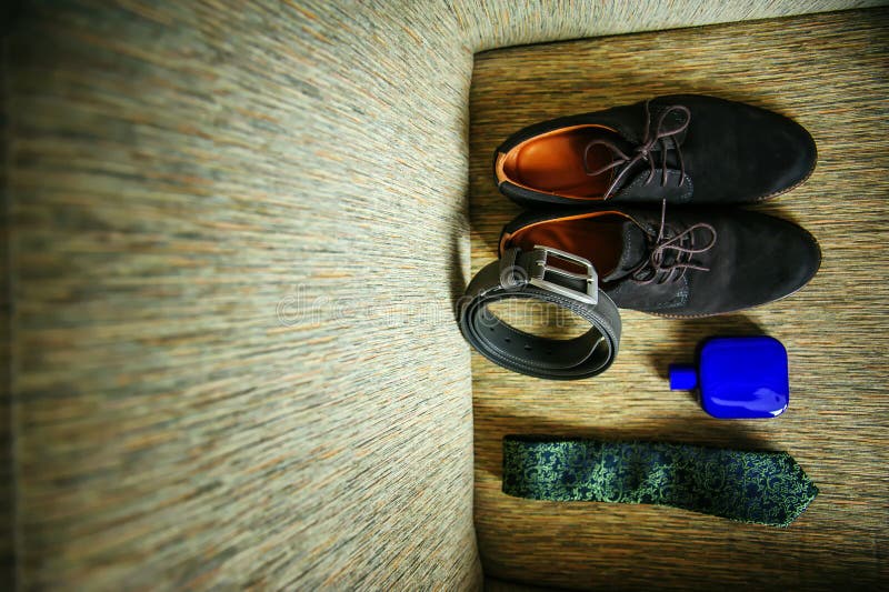 Wedding accessories for the groom, top view. Suede shoes, black leather belt, tie, eau de toilette stock photos Wedding accessories for the groom, top view. Suede shoes, black leather belt, tie, eau de toilette stock photos