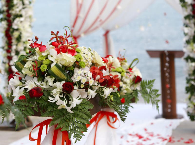 Wedding altar on beach bouquet of flowers in foreground. Wedding altar on beach bouquet of flowers in foreground.