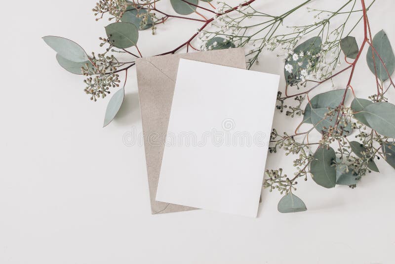 Wedding, birthday stationery composition. Blank greeting card, invitation mockup and craft envelope. Green Eucalyptus