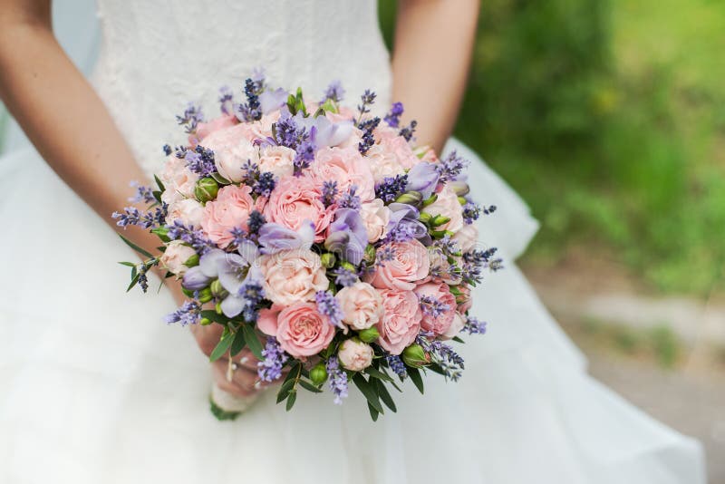 Wedding bouquet of lavender, roses and peonies.
