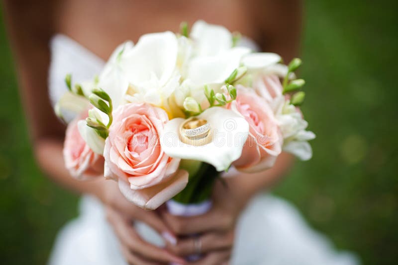 Wedding Bouquet with Rings on it in the Hands of the Bride Stock Image ...
