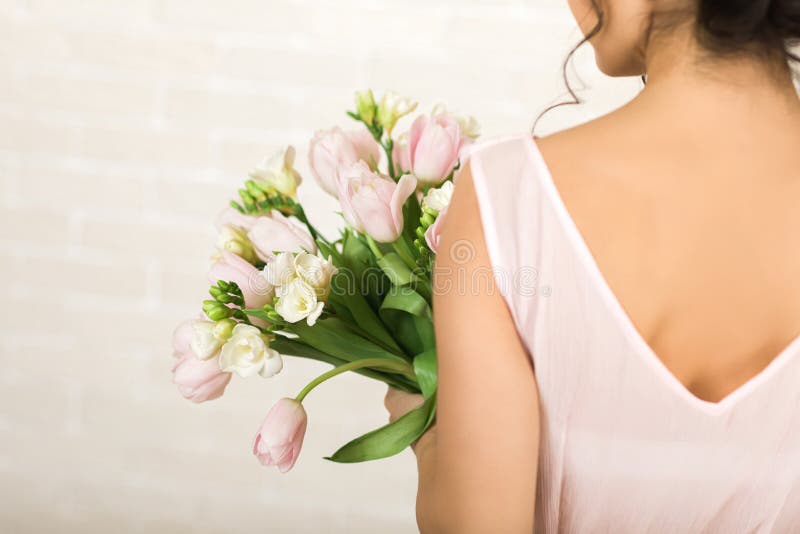 Wedding bouquet of pink tulips in bride`s hands