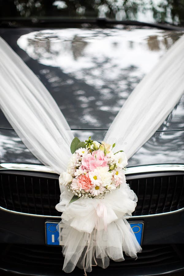 Wedding Car Decorated with a Bright Bouquet and Ribbons Stock Photo