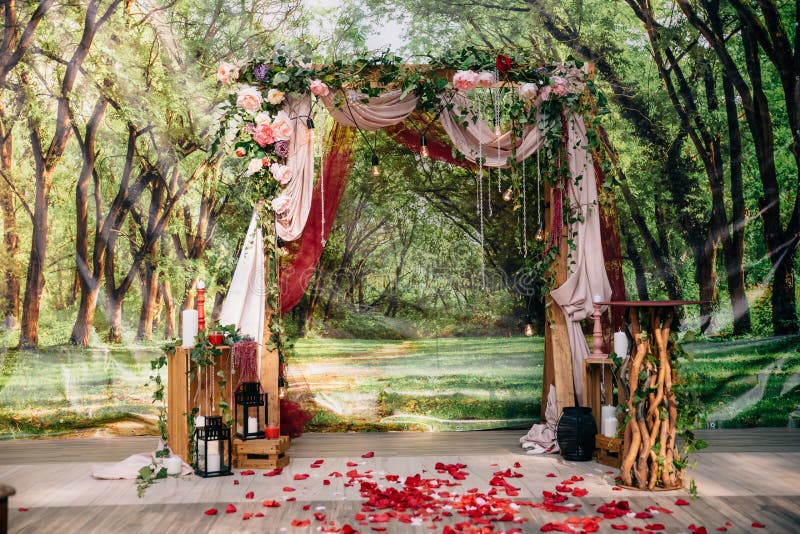 Wedding ceremony arch, altar decorated with flowers on the lawn.