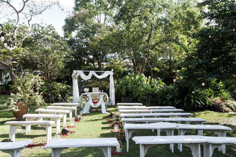 Wedding ceremony arch, altar decorated with flowers on the lawn.