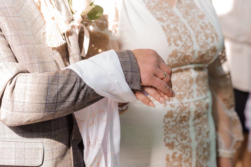 Wedding Ceremony in the Church. Hands of the Bride and Groom. Wedding