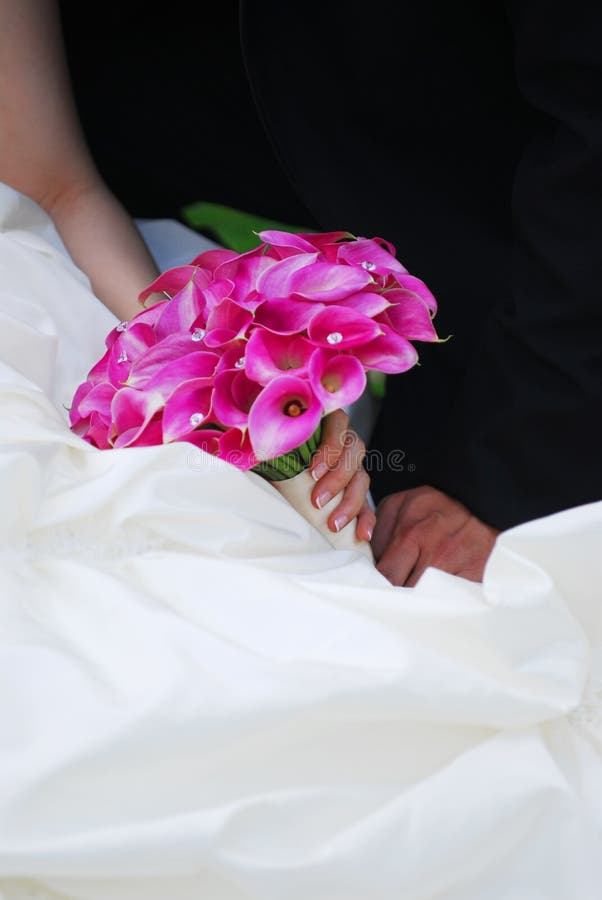 Bride and groom. Closeup on wedding bouquet. Bride and groom. Closeup on wedding bouquet.