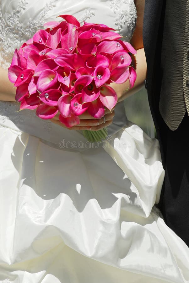 Bride and groom. Closeup on wedding bouquet. Bride and groom. Closeup on wedding bouquet.