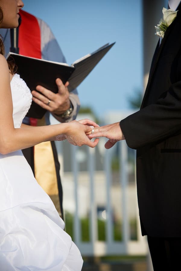 Wedding couple holding hands during the ceremony