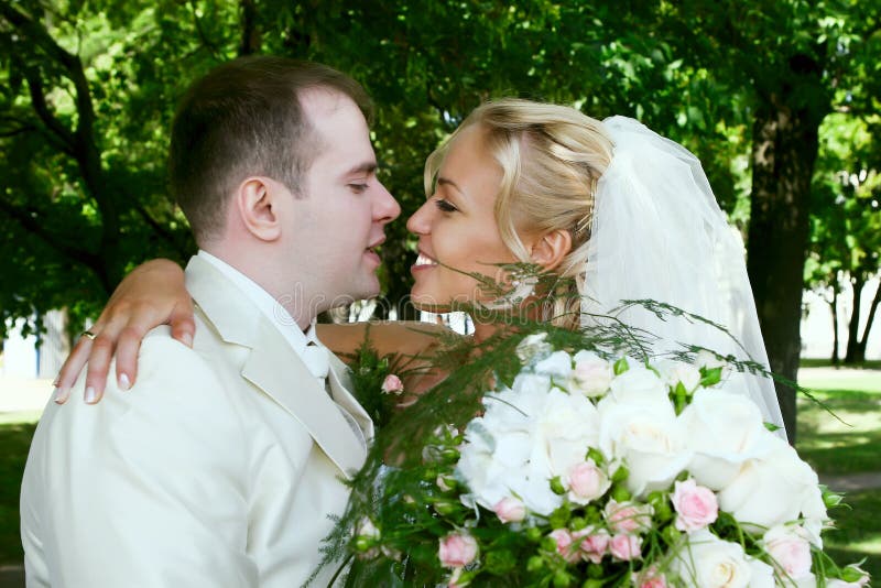 A happy wedding couple in garden. A happy wedding couple in garden