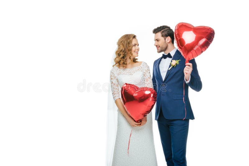 Wedding couple with red heart shaped balloons