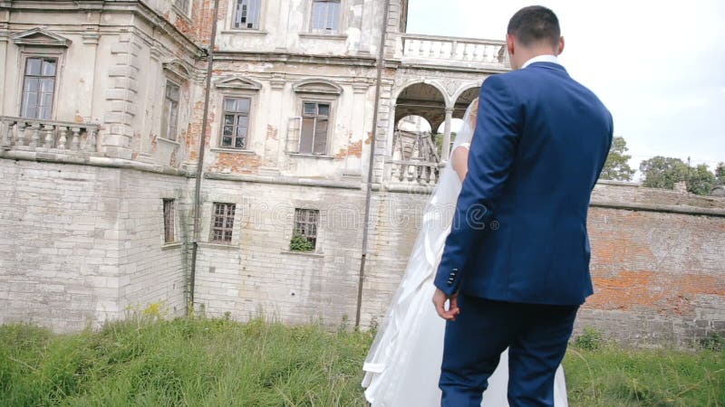 Wedding couple in tender loving care near the castle stock video footage Wedding couple in tender loving care near the castle stock video footage