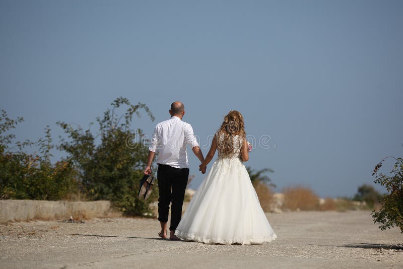 Wedding couple walking, back side stock image Wedding couple walking, back side stock image