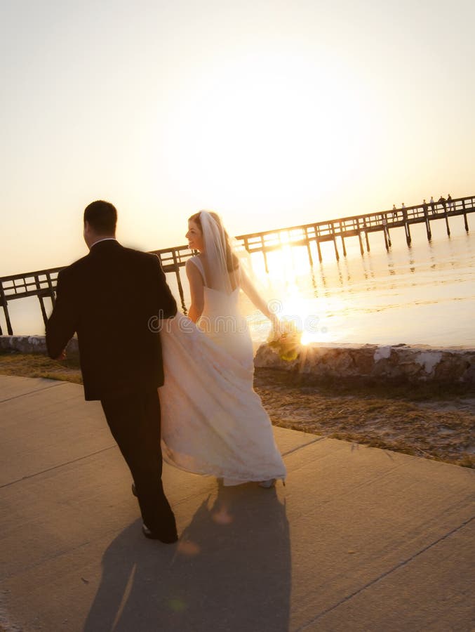 Wedding couple walking into sunset royalty free stock photos Wedding couple walking into sunset royalty free stock photos