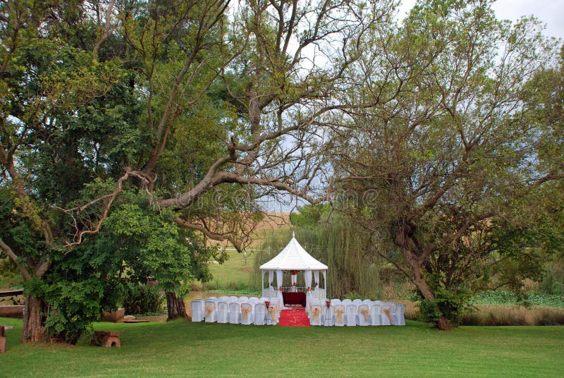 Image of an outdoor style wedding ceremony venue setting. Image of an outdoor style wedding ceremony venue setting.