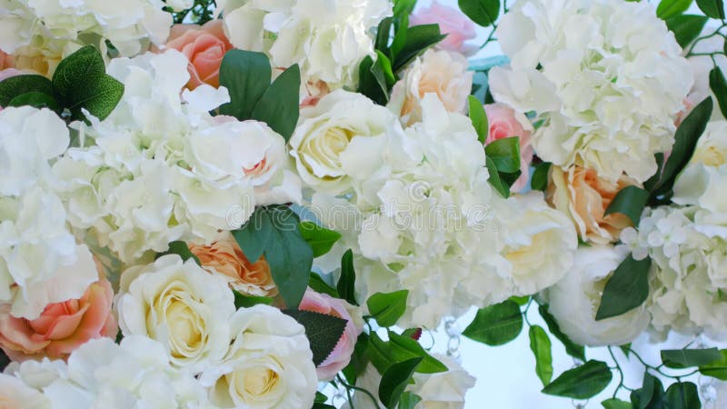 Wedding decor, white wedding arch decorated with roses, wedding ceremony on the beach, preparation for wedding ceremony