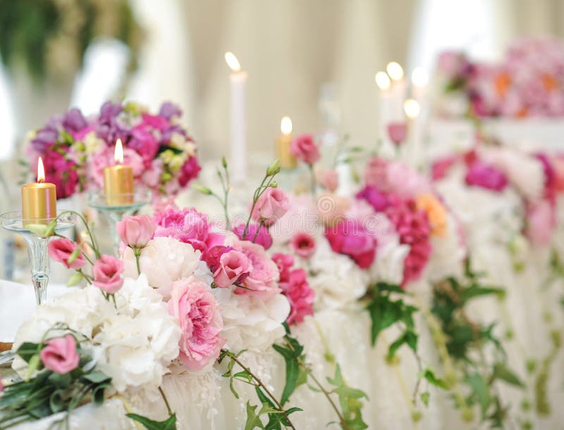 Wedding decoration on table. Floral arrangements and decoration. Arrangement of pink and white flowers in restaurant for event