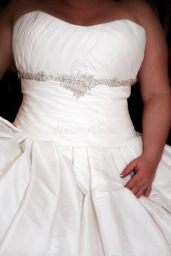 A bride sitting in a beautiful wedding dress.