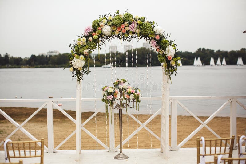 View of wedding floral arch on the beach