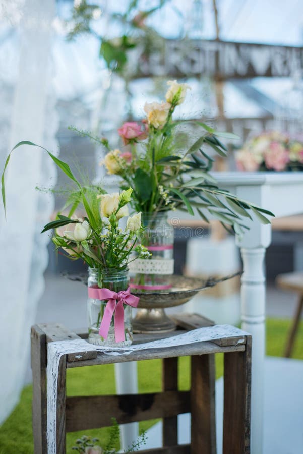 Beautiful flower decoration for wedding n front of a small altar for an outdoor event. White and green colors are dominating. Beautiful flower decoration for wedding n front of a small altar for an outdoor event. White and green colors are dominating.