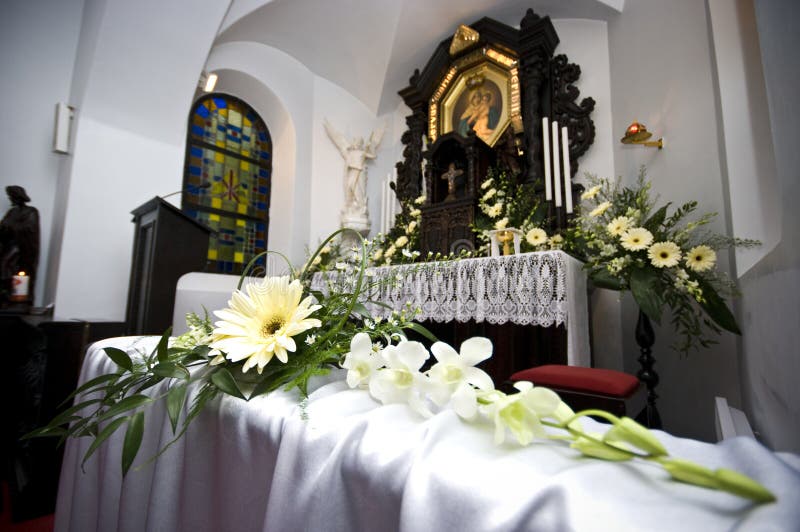 Close up of decorative wedding flowers in church.