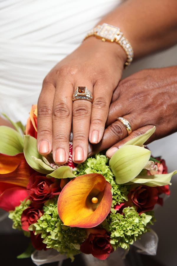 Wedding Hands and Rings on Tropical Bouquet stock photography