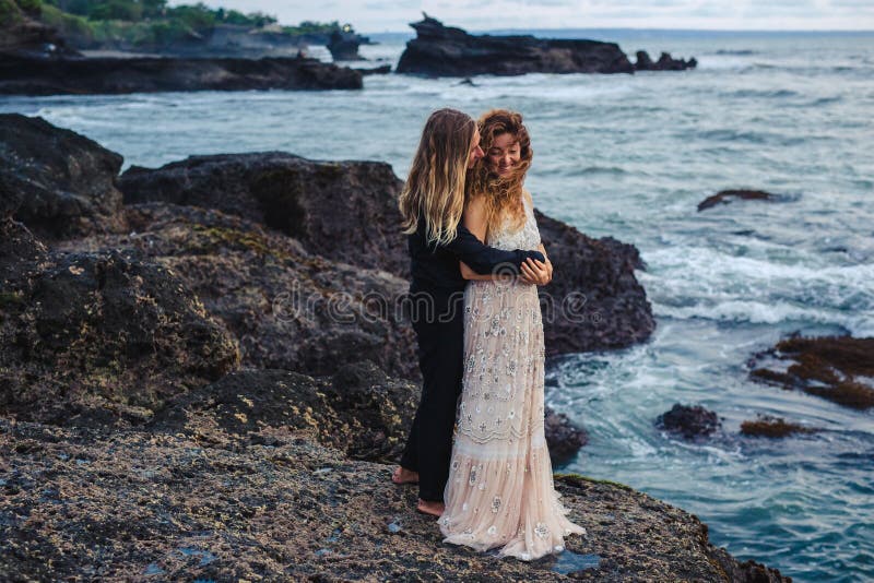 Wedding lovestory, just married couple near the ocean at sunset royalty free stock photos Wedding lovestory, just married couple near the ocean at sunset royalty free stock photos
