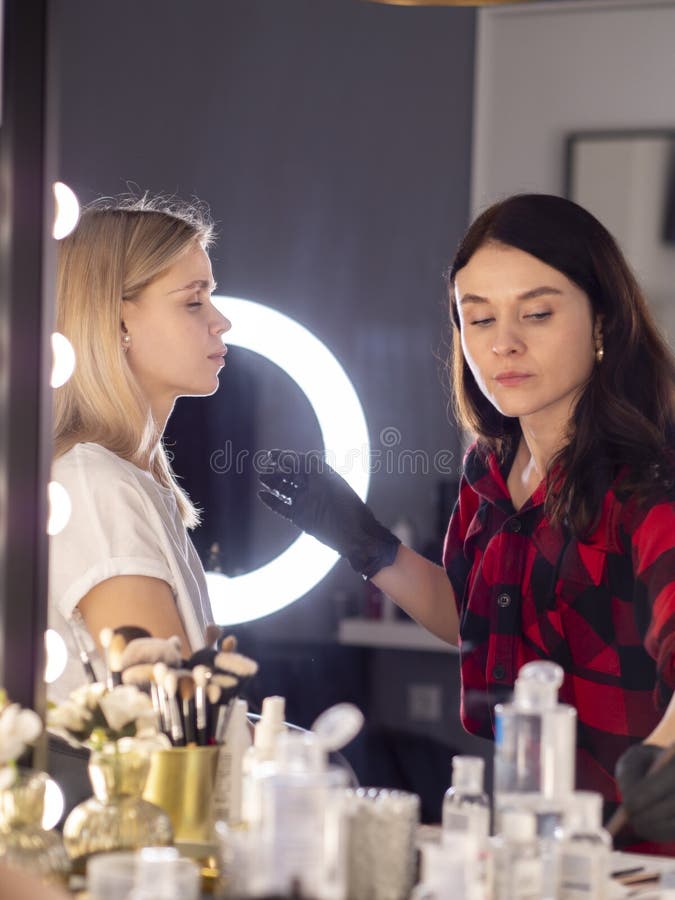 Wedding Makeup Artist Making a Make Up for Bride in a Salon Stock Photo